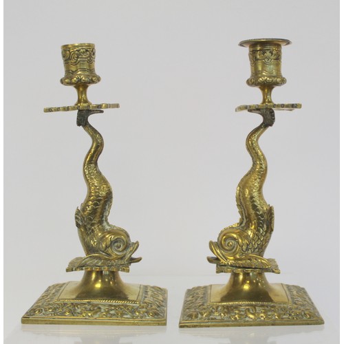 238 - Pair of brass candlesticks with foliate moulded sconces and drip trays on dolphin moulded columns an... 