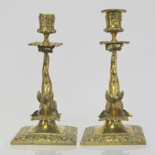 238 - Pair of brass candlesticks with foliate moulded sconces and drip trays on dolphin moulded columns an... 