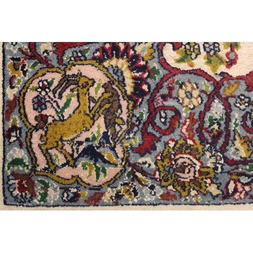 190 - Persian Qum (Qom) rug, the cream field with central flowerhead lozenge, floral sprays and border wit... 