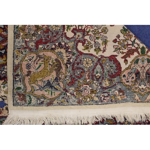 190 - Persian Qum (Qom) rug, the cream field with central flowerhead lozenge, floral sprays and border wit... 