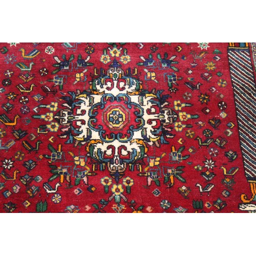 191 - Persian Qashqai wool rug, the red field with central medallion, flowers and birds, two columns with ... 