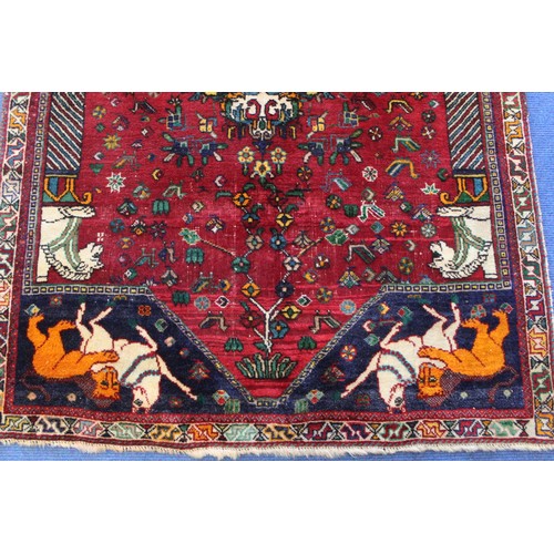 191 - Persian Qashqai wool rug, the red field with central medallion, flowers and birds, two columns with ... 