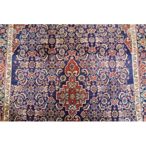 192 - Persian Bijar (Bidjar) rug with central lozenge on blue field with stylised floral medallions, spand... 