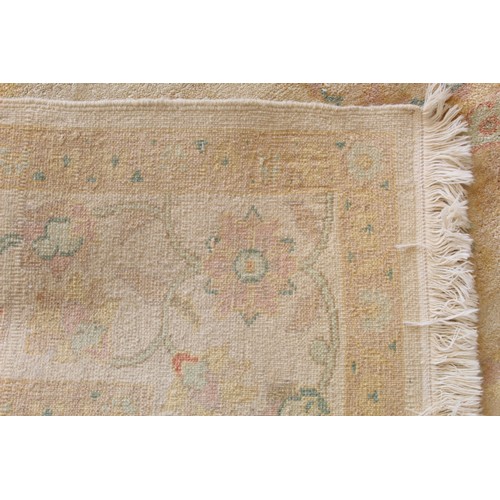 194 - Turkish Usak (Oushak) wool on cotton carpet, the cream ground with pale pastel floral and scroll dec... 