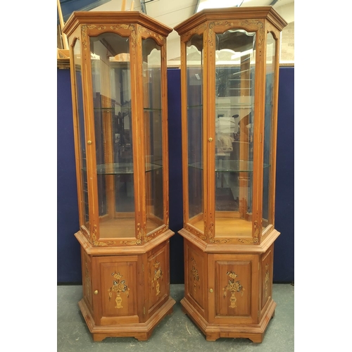 477 - Pair of modern Chinese glazed display cabinets of octagonal form, the glazed door, enclosing two gla... 