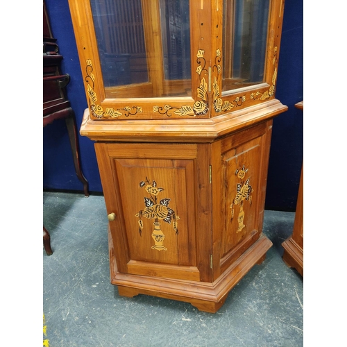 477 - Pair of modern Chinese glazed display cabinets of octagonal form, the glazed door, enclosing two gla... 