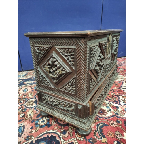 478 - Continental carved coffer, the hinged rectangular top with metal lock and escutcheon, carved profuse... 