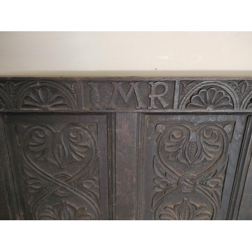 482 - Charles I period carved oak hall bench, inscribed IMR and carved with floral panels and swags to the... 