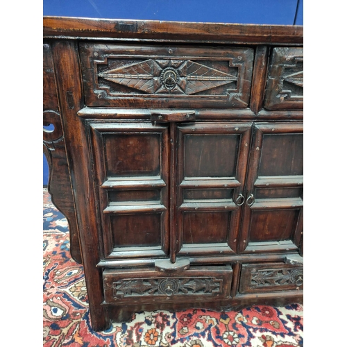 483 - Chinese lacquer altar cabinet, of sleigh form, with two small carved drawers above two doors enclosi... 