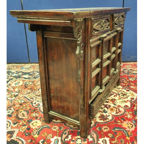 483 - Chinese lacquer altar cabinet, of sleigh form, with two small carved drawers above two doors enclosi... 