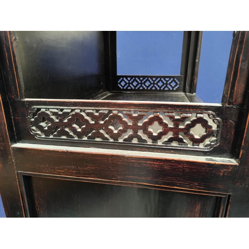 484 - Chinese lacquer display stand, with open section above shelving and a long drawer, carved panels to ... 