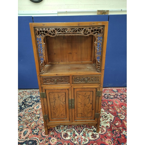 485 - Chinese pine cupboard, with an open section to the top, decorated with Chinese fretwork, above two s... 