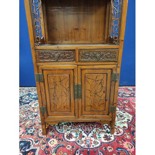 485 - Chinese pine cupboard, with an open section to the top, decorated with Chinese fretwork, above two s... 