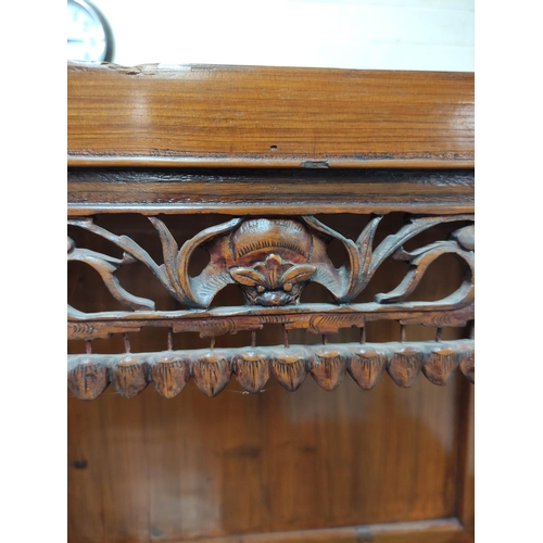 485 - Chinese pine cupboard, with an open section to the top, decorated with Chinese fretwork, above two s... 