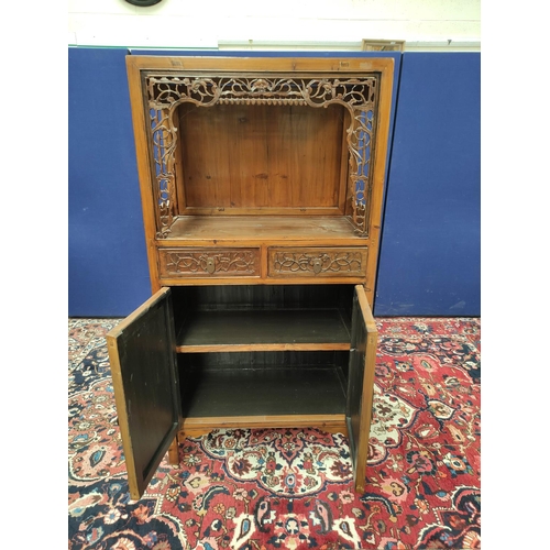 485 - Chinese pine cupboard, with an open section to the top, decorated with Chinese fretwork, above two s... 