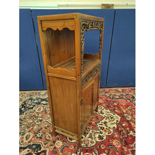 485 - Chinese pine cupboard, with an open section to the top, decorated with Chinese fretwork, above two s... 