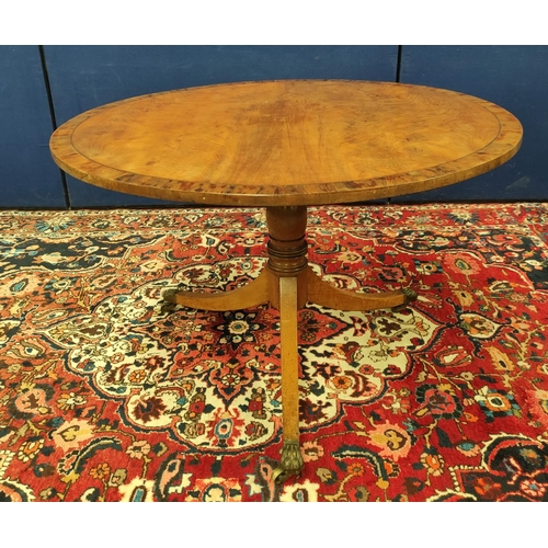 487 - Mahogany breakfast table, the circular snap-action top on a turned column and tripod supports, with ... 