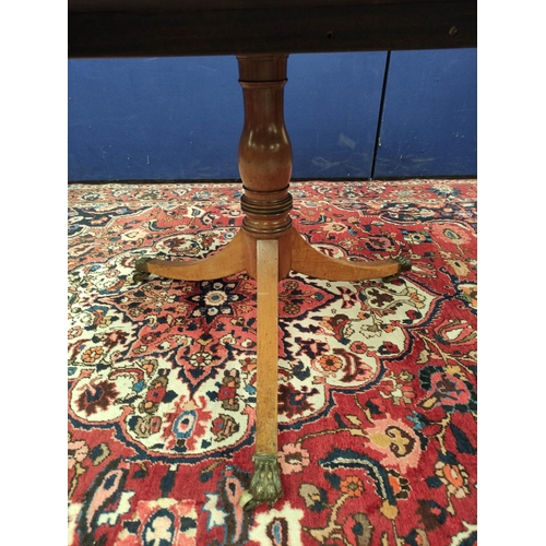 487 - Mahogany breakfast table, the circular snap-action top on a turned column and tripod supports, with ... 