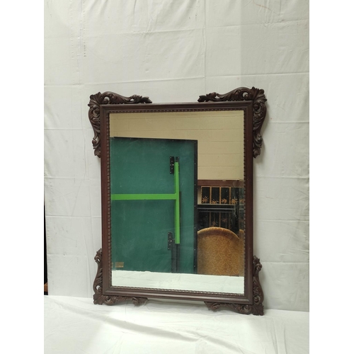 493 - Chinese hardwood wall mirror decorated with shell and acanthus moulded appliques. 96cm high, 77cm wi... 