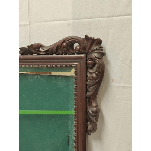 493 - Chinese hardwood wall mirror decorated with shell and acanthus moulded appliques. 96cm high, 77cm wi... 