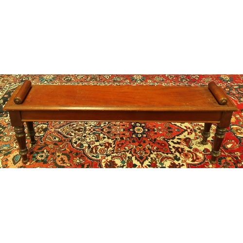 494 - Late Victorian mahogany hall bench with a cylindrical scroll terminal to either side of the seat, on... 