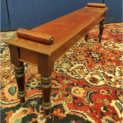 494 - Late Victorian mahogany hall bench with a cylindrical scroll terminal to either side of the seat, on... 