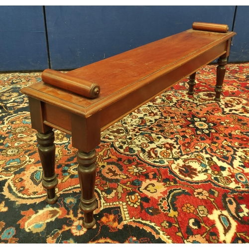 494 - Late Victorian mahogany hall bench with a cylindrical scroll terminal to either side of the seat, on... 