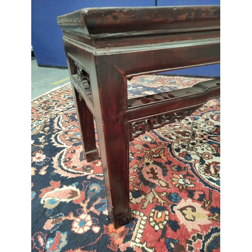 495 - Antique Chinese lacquer bench, the rectangular top with pierced frieze sides and fret scrolls above ... 