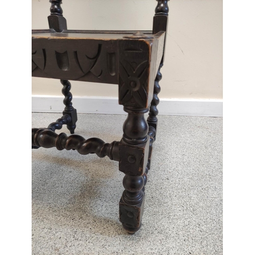 506 - Jacobean revival carved oak hall chair, with a carved leaf and scroll surmount, above carved panel d... 