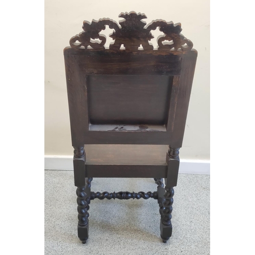 506 - Jacobean revival carved oak hall chair, with a carved leaf and scroll surmount, above carved panel d... 