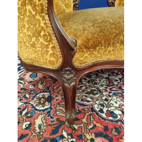 509 - Victorian mahogany scroll end settee upholstered in later gold coloured button back dralon, decorate... 