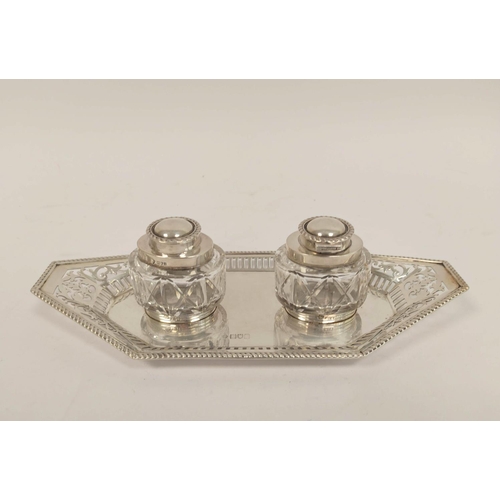 149 - Silver inkstand, pierced with angled ends and two oval cut glass receivers by Huttons, 1906, weight ... 