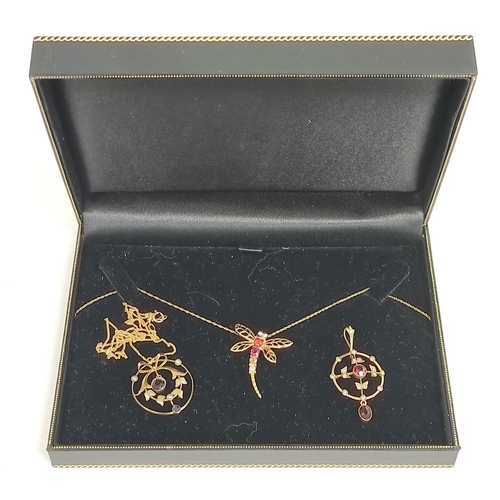 93 - Two gold circular pendants with garnets and pearls and another a garnet set dragon fly with two neck... 