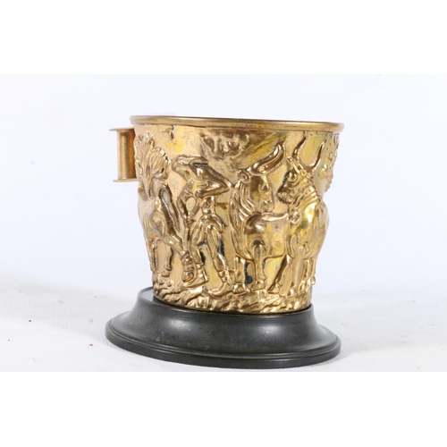 47 - Small gilded cup on stand decorated with African scene.