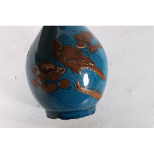 91 - Oriental style blue ground bottle vase decorated with onlaid bird and flowers, 24cm.