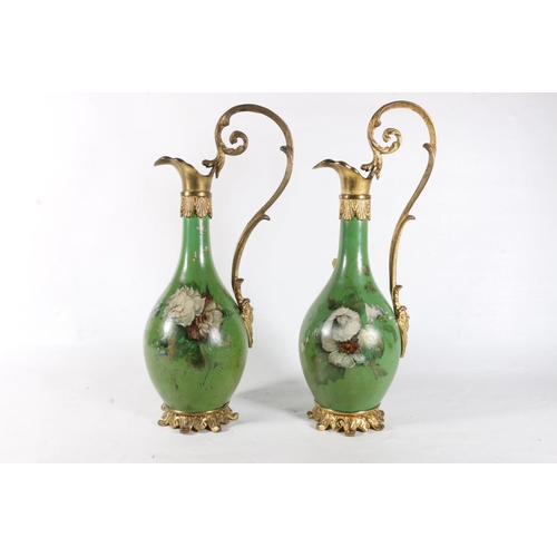 92 - Pair of French green lacquered ewers with hand painted floral decoration, 31cm.