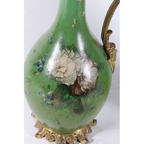 92 - Pair of French green lacquered ewers with hand painted floral decoration, 31cm.