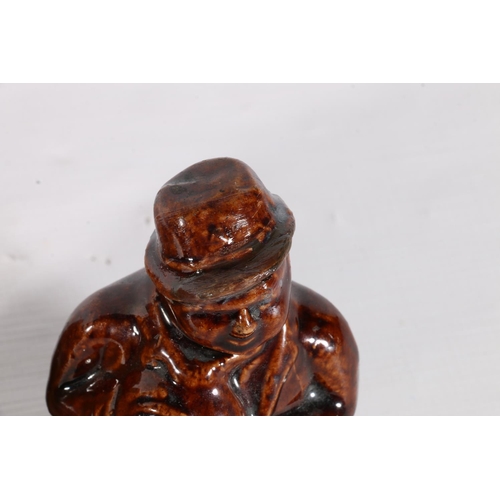 95 - Two treacle glazed money banks in the form of seated gentlemen and a salt glazed money bank of boot ... 