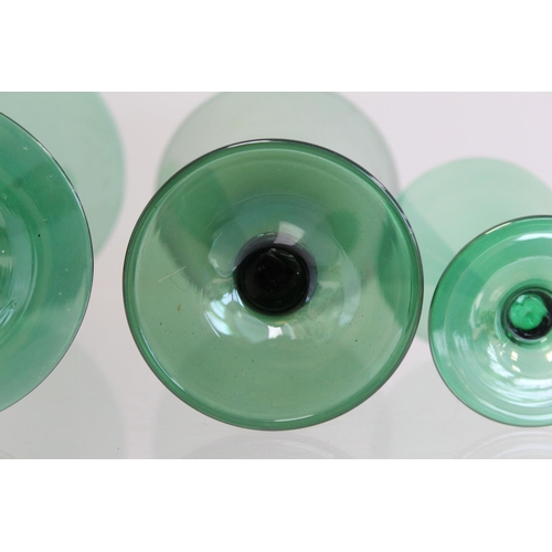 206 - Art Deco green lustre glass part suite of drinking glasses, all with conical bowls on short waisted ... 