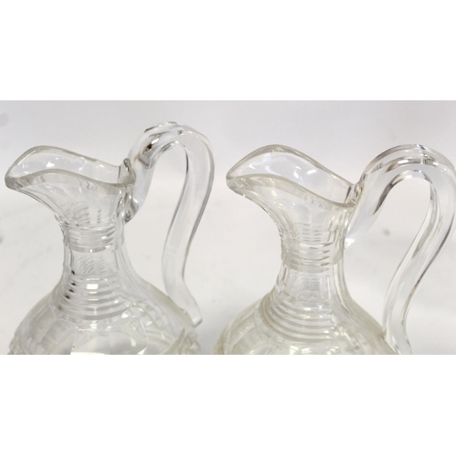 211 - Pair of cut glass wine ewers of baluster form with single scroll handles, blaze, facet and diamond c... 