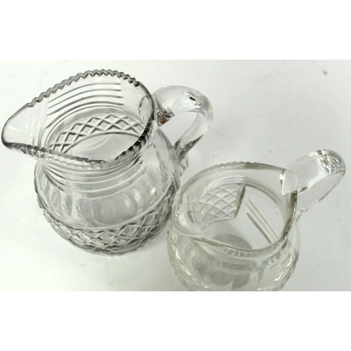 211 - Pair of cut glass wine ewers of baluster form with single scroll handles, blaze, facet and diamond c... 