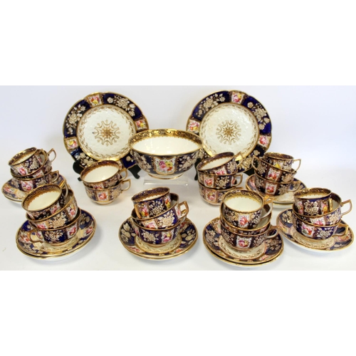 215 - Early 19th century English porcelain part tea set with polychrome painted floral panels on a dark bl... 