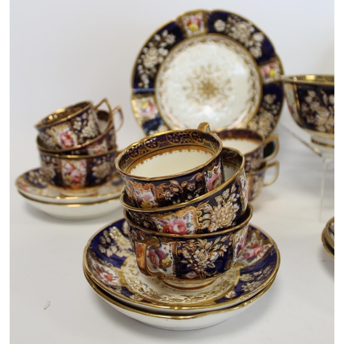 215 - Early 19th century English porcelain part tea set with polychrome painted floral panels on a dark bl... 