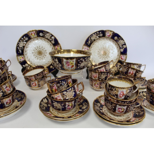 215 - Early 19th century English porcelain part tea set with polychrome painted floral panels on a dark bl... 