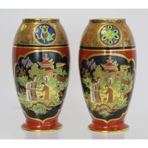 218 - Matched pair of Carlton Ware vases of footed ovoid form decorated in polychrome and gilt, the terrac... 