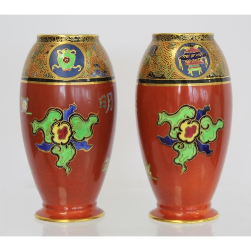 218 - Matched pair of Carlton Ware vases of footed ovoid form decorated in polychrome and gilt, the terrac... 