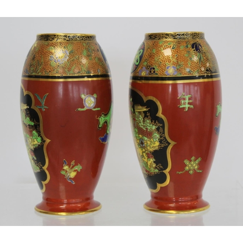 218 - Matched pair of Carlton Ware vases of footed ovoid form decorated in polychrome and gilt, the terrac... 