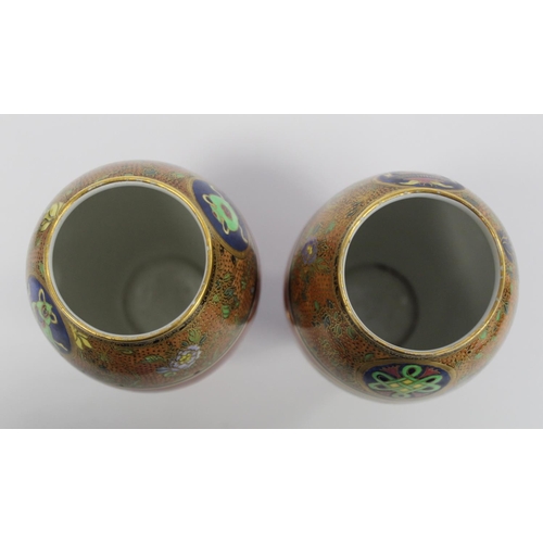 218 - Matched pair of Carlton Ware vases of footed ovoid form decorated in polychrome and gilt, the terrac... 