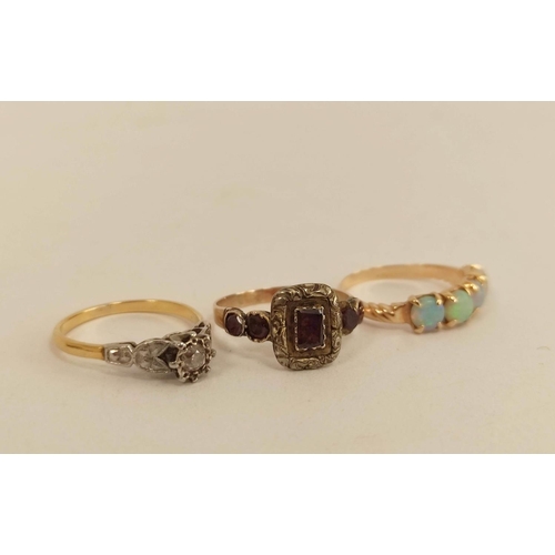 67 - Victorian garnet ring, a diamond solitaire ring and another with four opals, all gold. 8.7g (3).