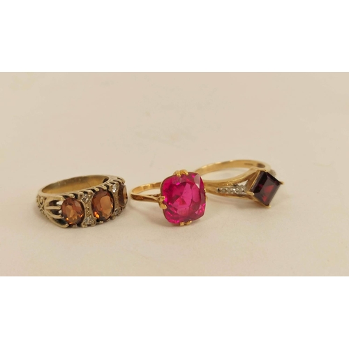 61 - Red spinel ring, another with square garnet and a citrine three stone ring, all 9ct gold. (3). 12.6g